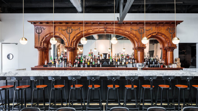 Interior photo of Middle West Spirits featuring the antique bar.