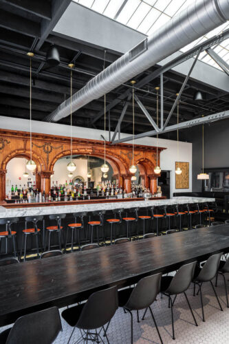 Interior photo of Middle West Spirits featuring the antique bar.