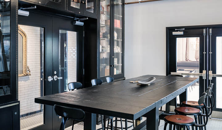 Interior photo of Middle West Spirits featuring a large group table and chairs.