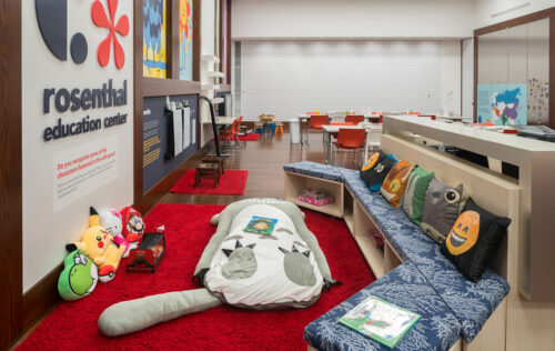 A open reading space with couches, a beanbag chair, and fuzzy carpets at the Rosenthal Education Center at the Cincinnati Art Museum.