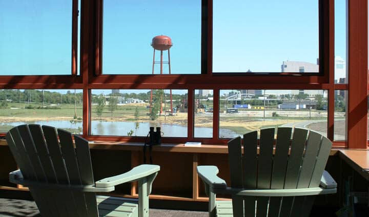 Interior view of the Grange Audubon Center in Columbus, Ohio. A single-story building with stone exterior and a lobby with glass walls.