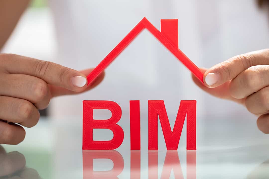 Businesswoman Holding Roof Over BIM Text On Reflective Desk