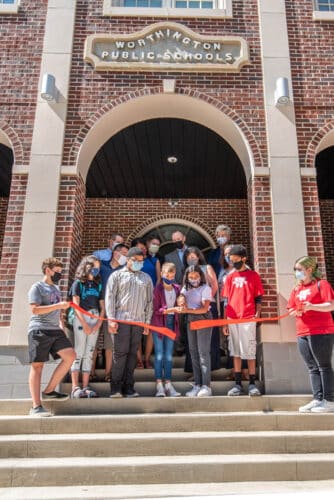 Students cut a red ribbon with large scissors to open the newly renovated Kilbourne Middle School in Worthington, Ohio