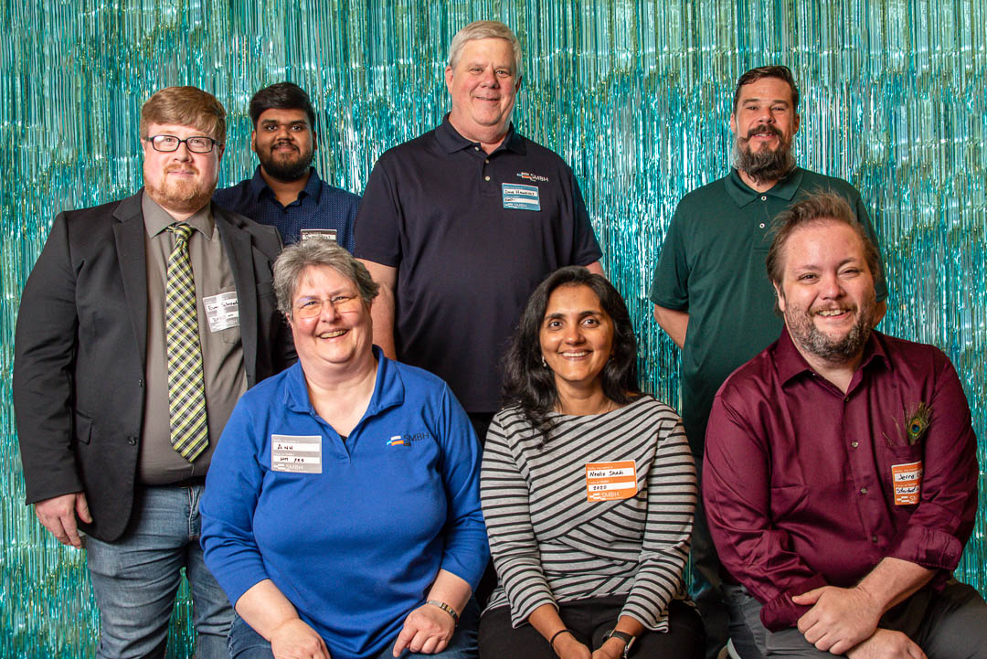 A group photo of the BIM team including Evan Schroeder, Parth Patel, Dave Hawkins, Chris Cormany, Ann Strosnider, Neelie Shah, and Jerry Marselle.