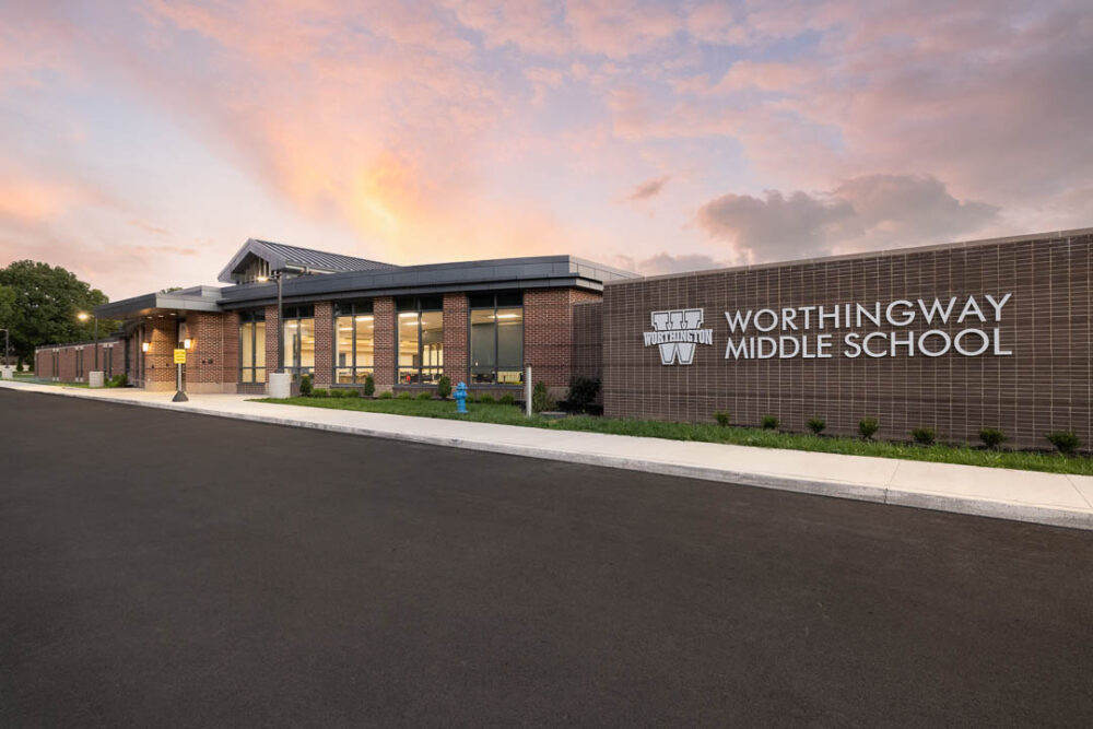 Exterior photo of Worthingway Middle School in Westerville, Ohio. A one-story building with a red brick facade and dark roof.