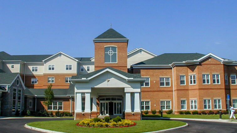 Exterior photo of Mother Angeline McCrory Manor, a nursing and assisted living facility in Columbus, Ohio. Features brick and stone exteriors on the multi-story building.