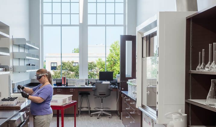 An interior photo of a small lab in Moseley Hall at Bowling Green State University. The room is long and narrow, with tall ceilings and large windows at the end of the room, which let in lots of natural light.