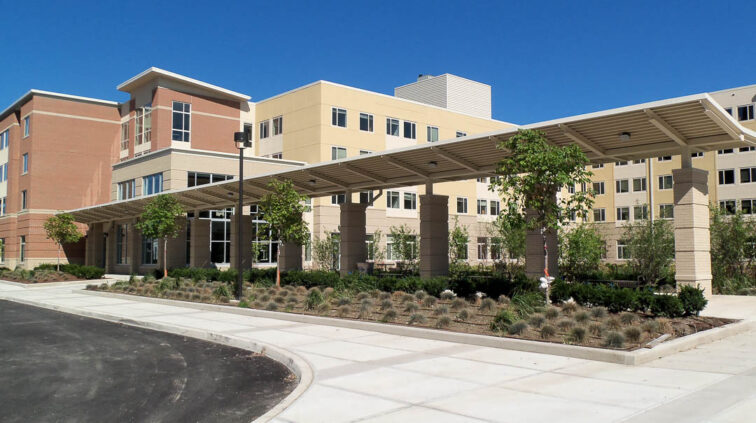 An exterior view of Falcon Heights and Centennial Hall at Bowling Green State University. The multi-story building features brick and stucco.