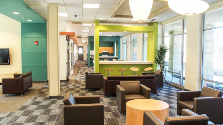 An interior view a common area at Falcon Heights and Centennial Hall at Bowling Green State University. Photo looks at a smaller common area for students to lounge or gather, with lots of seating in small groups that could easily be reconfigured for a large group.