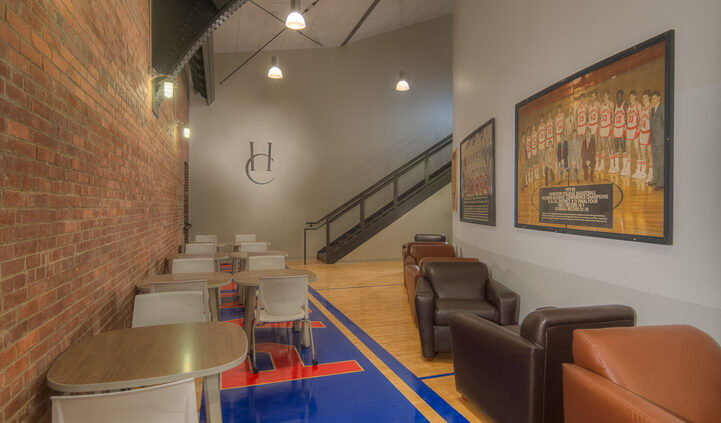 Photo of a common area in Lynn Hall at Hanover College. Features a vaulted ceilings and a brick wall, with comfortable seating for small groups.