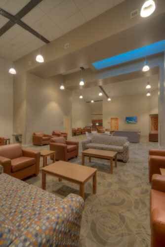Photo of a common area in Lynn Hall at Hanover College. Features a vaulted ceilings and a brick wall, with comfortable seating for small groups.