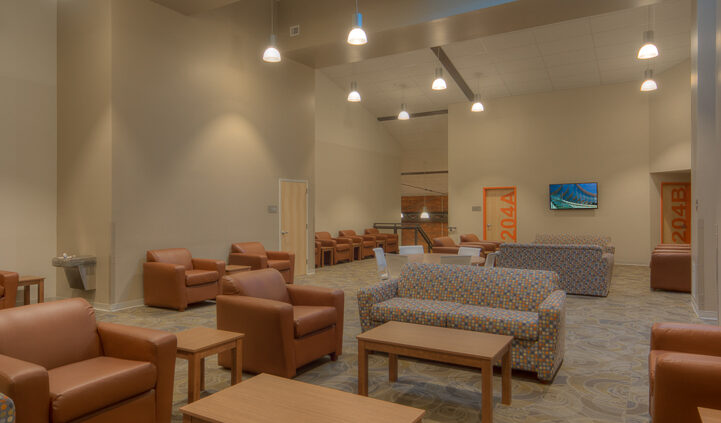 Photo of a common area in Lynn Hall at Hanover College. Features a vaulted ceilings and a brick wall, with comfortable seating for small groups.