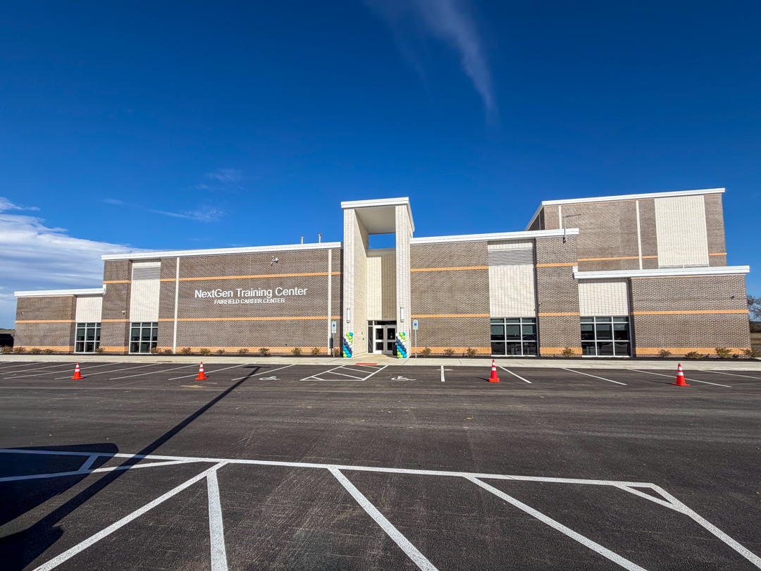 A photograph of the exterior of the new Eastland Fairfield NextGen Training Facility. A modern brick building that is a single-story.